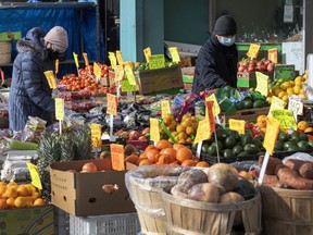 Shoppers browse produce at a green grocer, in Toronto, Jan. 27, 2021. The Ontario Living Wage Network has updated their living wages across the province in the face of inflation.