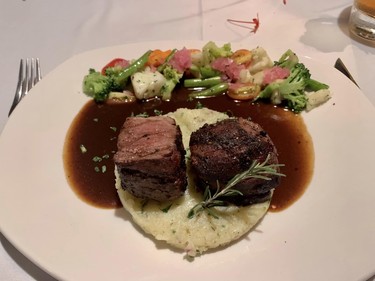 A tasty char-grilled 8 oz. filet mignon in a red wine demi-glace, served with spicy smashed potatoes, steamed broccoli and pickled vegetables at Matachica Resort and Spa's Mambo Restaurant.