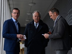 Former Dutch Police Head of Central Crime Investigation Department Wilbert Paulissen (left) and Piet Ploeg (middle), board member of Stichting Vliegamp MH17 foundation and relative of victims, wait at the Schiphol Judicial complex prior to the verdict in the trial of four men prosecuted for their involvement in the Malasia Airlines MH17 flight downing case, in Badhoevedorp on November 17, 2022
