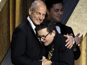 Woody Harrelson congratulates Michael J. Fox, winner of the Jean Hersholt Humanitarian Award, onstage during the Academy of Motion Picture Arts and Sciences 13th Governors Awards at Fairmont Century Plaza on Nov. 19, 2022 in Los Angeles, Calif.