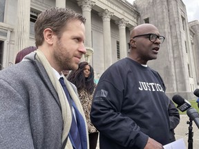 Attorney Richard Davis, left, of the Innocence Project New Orleans, stands next to Raymond Flanks outside the New Orleans criminal courthouse on Thursday, Nov. 17, 2022.