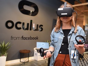 In this file photo taken on October 23, 2019, Facebook employee Elza Uzmanoff tries out an Oculus device at the company's corporate headquarters campus in Menlo Park, California.