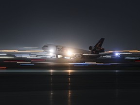 A FedEx plane lands at Pearson International Airport in Toronto on Wednesday, March 24, 2021.