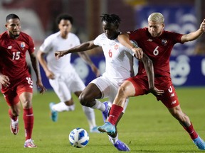 Panama's Cristian Martinez, center, and Canada's Ismael Kone battle for the ball during a qualifying soccer match for the FIFA World Cup Qatar 2022 in Panama City, Panama, Wednesday, March 30, 2022.