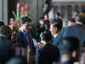 This handout photo released by the Office of the Prime Minister of Canada on Nov. 16, 2022 shows Canadian Prime Minister Justin Trudeau (left) speaking to Chinese President Xi Jinping as Trudeau arrives at the G20 in Bali on Nov. 15, 2022.