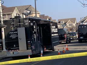 Police vehicles are seen outside a residence in Milton Wednesday, Nov. 23, 2022.