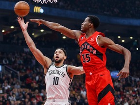 Ben Simmons of the Brooklyn Nets drives to the net against Christian Koloko of the Raptors during the first half at Scotiabank Arena on Wednesday, Nov. 23, 2022 in Toronto.
