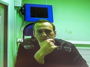 Russian opposition leader Alexei Navalny is seen on a TV screen, as he appears in a video link provided by the Russian Federal Penitentiary Service in a courtroom of the Second Cassation Court of General Jurisdiction in Moscow, Russia, Tuesday, Oct. 18, 2022.