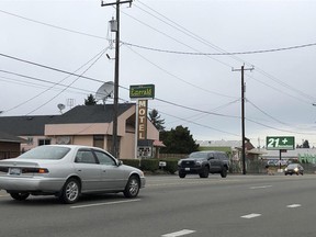 Cars drive by the Emerald Motel in North Seattle on Friday, Nov. 11, 2022.