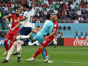 Soccer Football - FIFA World Cup Qatar 2022 - Group B - England v Iran - Khalifa International Stadium, Doha, Qatar - November 21, 2022
Iran's Alireza Beiranvand collides into Majid Hosseini resulting in being substituted off with a concussion injury.