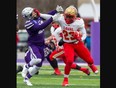 Laval Rouge et Or ball carrier Kalenga Muganda dismisses would-be Western Mustangs tackler Daniel Valente during the Mitchell Bowl at Alumni Stadium in London on Saturday November 19, 2022. Laval won the game 27-20 to earn a berth in the Vanier Cup. Derek Ruttan/The London Free Press