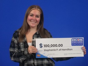Stephanie Powell-Larsen, 28, with her Lotto Max Encore winnings.