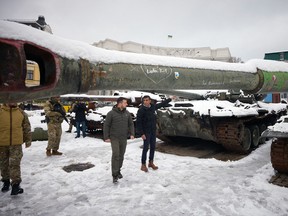 This handout picture taken and released by the Ukrainian presidential press service on November 19, 2022, shows Ukrainian President Volodymyr Zelensky and British Prime Minister Rishi Sunak visiting the exhibition of destroyed Russian military vehicles in Kyiv.