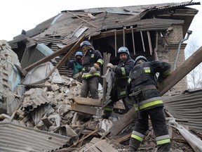 Rescuers clear debris of the destroyed two-storey maternity building in the town of Vilnyansk, southern Zaporizhzhia region, on November 23, 2022.