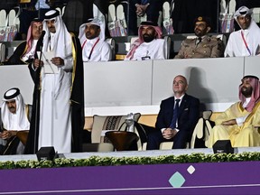 Qatar's Emir Sheikh Tamim bin Hamad al-Thani (second from left) delivers a speech next to Qatar's former Emir Sheikh Hamad bin Khalifa al-Thani (left), FIFA President Gianni Infantino (second from right) and Saudi Arabia's Crown Prince Mohammed bin Salman al-Saud during the opening ceremony ahead of the Qatar 2022 World Cup Group A football match between Qatar and Ecuador at the Al-Bayt Stadium in Al Khor, north of Doha on Nov. 20, 2022.