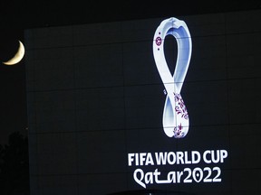 The 2022 Qatar World Cup logo is projected on the opera house of Algiers, Tuesday Sept. 3, 2019.