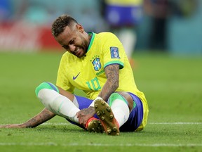Neymar of Brazil sits injured on the pitch  during the FIFA World Cup.