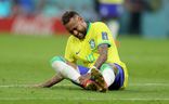 Neymar of Brazil sits injured on the pitch during the FIFA World Cup.