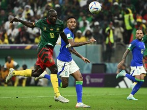 Cameroon forward Vincent Aboubakar (left) scores a goal against Brazil.