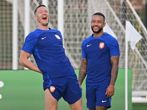 Netherlands' forwards Wout Weghorst (left) and Memphis Depay take part in a training session.