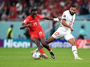 Canadian midfielder Ismael Kone (ledt) and Morocco's Sofiane Boufal fight for the ball.