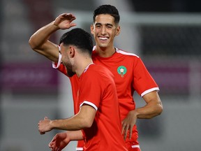 Morocco's Nayef Aguerd laughs during training.