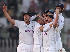 Ollie Robinson, Jack Leach and Ben Stokes of England celebrate winning the First Test Match between Pakistan and England.