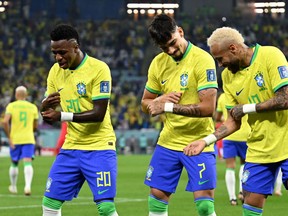 Brazil's Vinicius Junior (left) celebrates scoring his team's first goal with midfielder Lucas Paqueta forward Neymar.