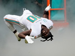 Tyreek Hill of the Miami Dolphins runs onto the field during player introductions.
