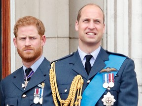 Prince Harry and Prince William watch a flypast to mark the centenary of the Royal Air Force from the balcony of Buckingham Palace on July 10, 2018 in London.
