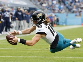 Trevor Lawrence of the Jacksonville Jaguars dives in for a touchdown in the third quarter of the game against the Tennessee Titans at Nissan Stadium on Dec. 11, 2022 in Nashville, Tenn.