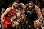 Kevin Durant of the Nets stiff-arms Fred VanVleet as he drives to the Raptors hoop last night at the Barclays Center. It was that kind of night for the Raptors. 
