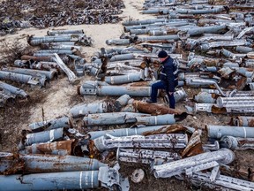 This aerial picture taken on December 7, 2022 shows an expert of the prosecutor's office examining collected remnants of shells and missiles used by the Russian army to attack the second largest Ukrainian city of Kharkiv, amid the Russian invasion of Ukraine.