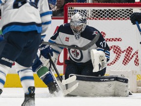 Goalie Connor Hellebuyck of the Winnipeg Jets makes a save against the Vancouver Canucks during the first period in NHL action on December, 17, 2022 at Rogers Arena in Vancouver, British Columbia, Canada.