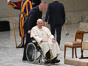 Pope Francis arrives in a wheelchair for the audience with managers and delegates of the Italy's CGIL trade union at the Vatican, on December 19, 2022.