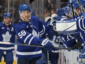 Michael Bunting of the Toronto Maple Leafs celebrates a goal against the Tampa Bay Lightning with teammates on the bench in the first period during an NHL game at Scotiabank Arena on December 20, 2022 in Toronto, Ontario, Canada.