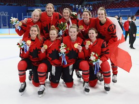 Gold medal winners Emma Maltais #27, Brianne Jenner #19, Jamie Lee Rattray #47, Laura Stacey #7, Marie-Philip Poulin #29, (front) Natalie Spooner #24, Sarah Fillier #10, Claire Thompson #42 and Erin Ambrose #23 of Team Canada celebrate during the medal ceremony after the Women’s Ice Hockey Gold Medal match between Team Canada and Team United States on Day 13 of the Beijing 2022 Winter Olympic Games at Wukesong Sports Centre on February 17, 2022 in Beijing, China. (Photo by Bruce Bennett/Getty Images)