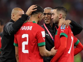 Achraf Hakimi and Hakim Ziyech of Morocco celebrate after the team's victory against Portugal.