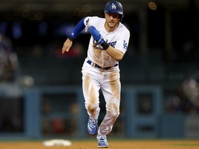 Trea Turner of the Los Angeles Dodgers runs home to score in the third inning during game one of the National League Division Series against the San Diego Padres at Dodger Stadium on October 11, 2022 in Los Angeles, California.