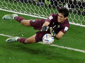 Yassine Bounou of Morocco makes a save against a penalty by Carlos Soler of Spain in the penalty shoot out during the FIFA World Cup Qatar 2022 Round of 16 match between Morocco and Spain at Education City Stadium on December 06, 2022 in Al Rayyan, Qatar.