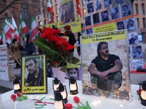 Portraits of Majid Reza Rahnavard, 23, and Mohsen Shekari, 23, both of whom were recently executed by Iranian authorities, stand on a table among candles during a demonstration by supporters of the National Council of Resistance of Iran outside the German Foreign Ministry on December 12, 2022 in Berlin, Germany.