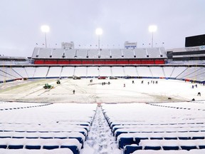 A general view as stadium workers clear snow off the field prior to a game between the Miami Dolphins and Buffalo Bills at Highmark Stadium on December 17, 2022 in Orchard Park, New York.