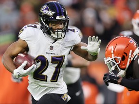 CLEVELAND, OHIO - DECEMBER 17: J.K. Dobbins #27 of the Baltimore Ravens carries the ball against the Cleveland Browns during the first quarter at FirstEnergy Stadium on December 17, 2022 in Cleveland, Ohio.