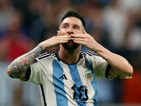Argentina's Lionel Messi celebrates after Julian Alvarez scores their third goal.