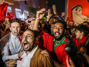 Morocco fans celebrate after their country's win against Portugal.