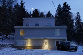 The moon rises on Nov. 29, 2022, as a police officer stands guard in his vehicle at the home where four University of Idaho students were found dead on Nov. 13, 2022 in Moscow, Idaho.
