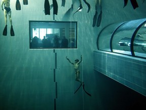 Italian former legend of free diving, Umberto Pelizzari (bottom) gives an apnea course at the "Y-40 The Deep Joy" swimming pool on December 8, 2014 in Montegrotto Terme, northeastern Italy.