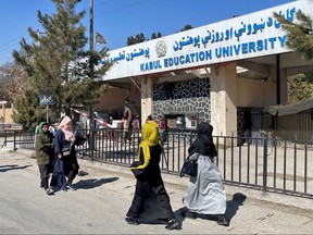 Female students walk in front of the Kabul Education University in Kabul, Afghanistan, Feb. 26, 2022.
