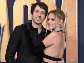 U.S. singer-songwriter Kelsea Ballerini (R) and Australian singer Morgan Evans arrive for the 57th Academy of Country Music awards at the Allegiant stadium in Las Vegas, Nevada on March 7, 2022.