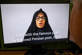 A person on November 28, 2022 watches Farideh Moradkhani, the niece of Supreme Leader Ali Khamenei, speaking in a video posted on YouTube. (Photo by AFP via Getty Images)